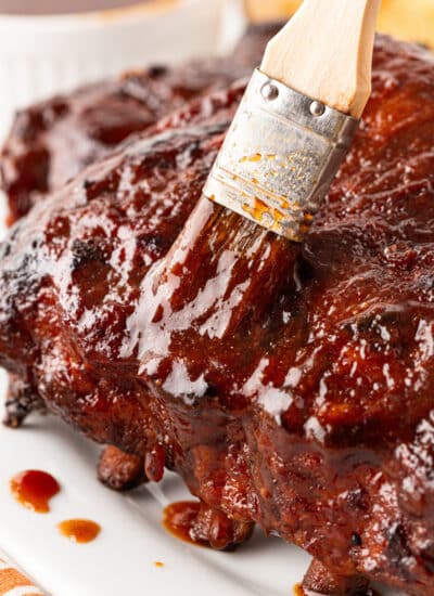 Brushing ribs with extra sauce.