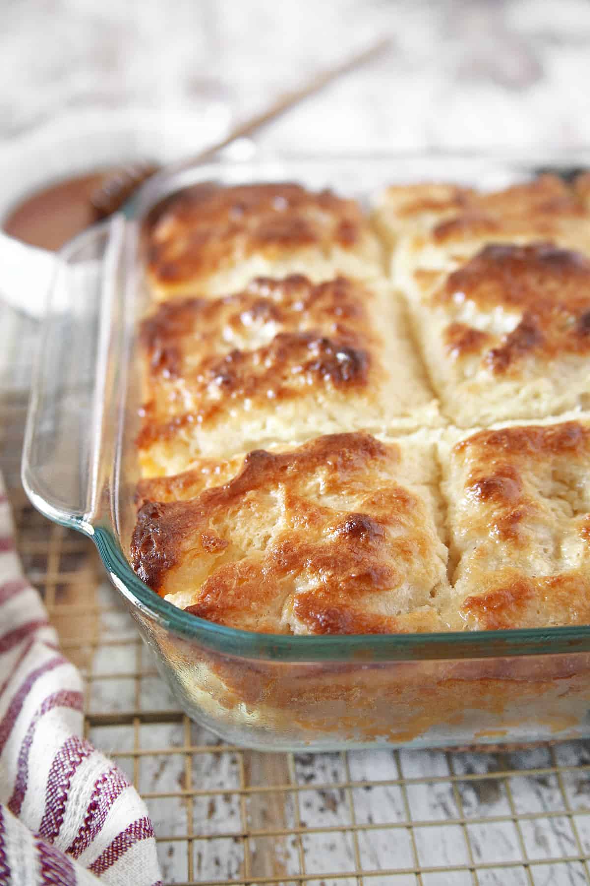 Butter Swim Biscuits are an amazing quick and easy baking powder bun that is soft and fluffy on the inside and crispy and buttery on the outside. Just the perfect biscuit!! Butter Swim Biscuits in a pan.
