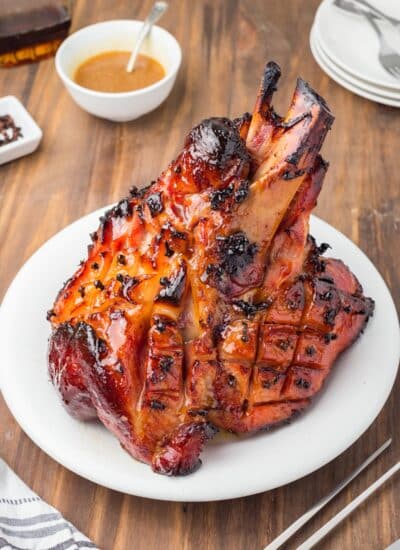 Cooked and glazed ham on a plate.