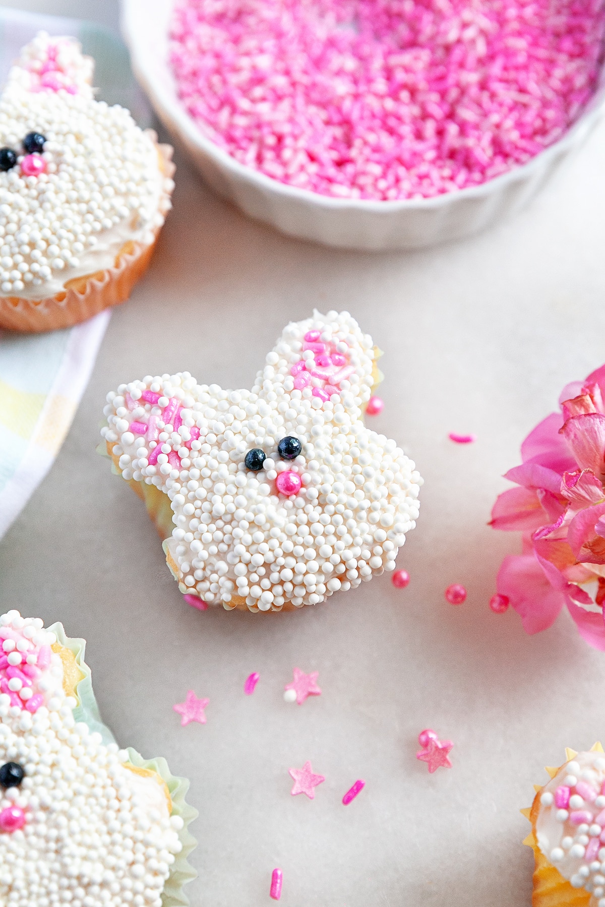 These Easter Bunny Cupcakes are not only delicious to eat but fun to make with the whole family. You don't need any fancy skills or special baking equipment either. Easter Bunny Cupcakes and sprinkles.