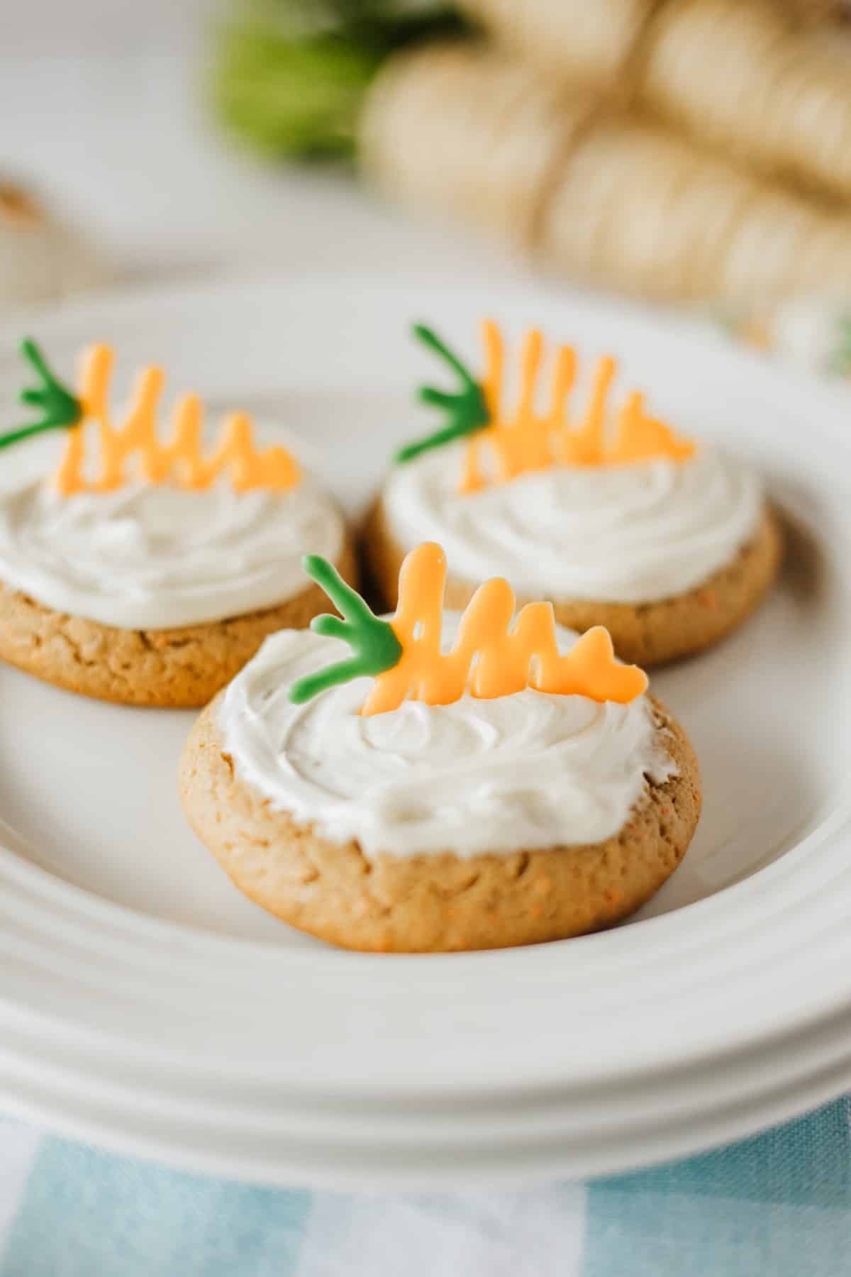 These Carrot Cake Cookies couldn't be easier with a mix and canned icing. All you need to do is a little candy carrot, and you have the most adorable cookie around. Close-up picture of Carrot Cake Cookies.