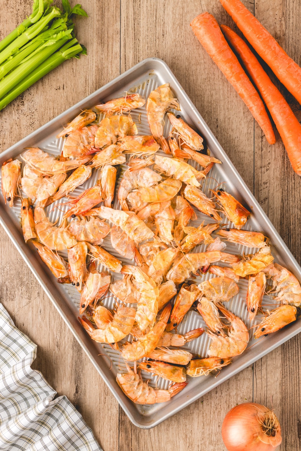 Try this less expensive cousin to Lobster Bisque. Shrimp Bisque is still bursting with great seafood flavor and is a perfect soup for summer to winter dining. Cooked shrimp shells and heads on a baking sheet.